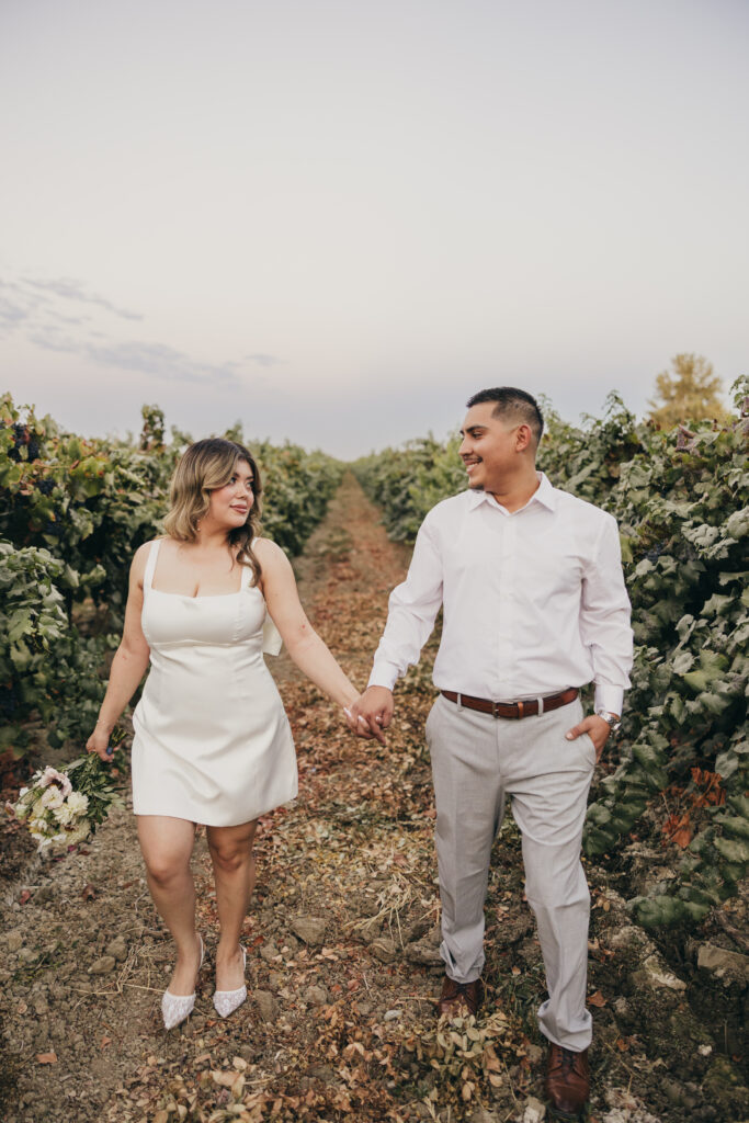 Joyful engagement photo of a couple walking hand in hand through a garden setting.
Winery Wedding 
Winery engagement session 