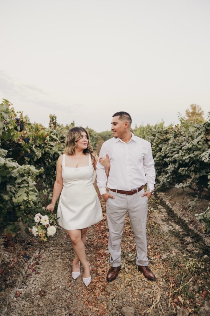 Couple in the vineyards with bouquet